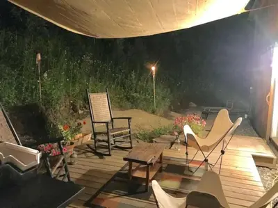 a patio with two chairs and a table and chairs at Sadawga Springs Retreat in Whitingham