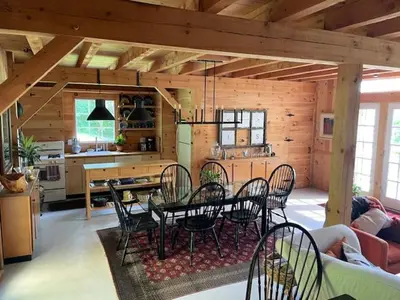 a room with a table and chairs in a kitchen at Sadawga Springs Retreat in Whitingham