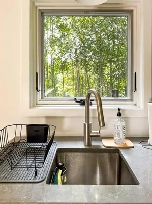 a sink in a kitchen with a window at Lil' Rita in Bloomville