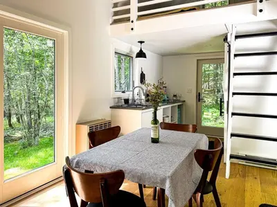 a kitchen and dining room with a table and chairs at Lil' Rita in Bloomville