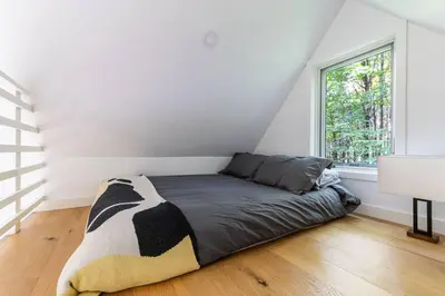a bedroom with a black and white bed and a window at Lil' Rita in Bloomville