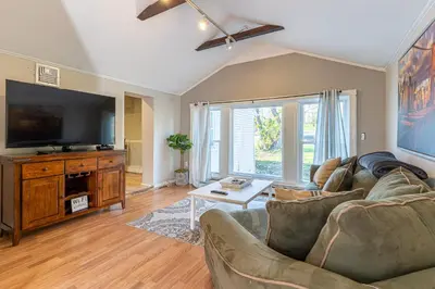 a living room with a couch and a flat screen tv at H2 1 Bedroom Downtown Stamford in Stamford