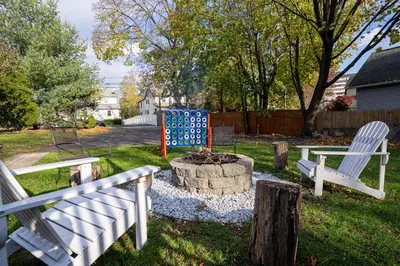 a yard with two benches and a fire pit at H2 1 Bedroom Downtown Stamford in Stamford