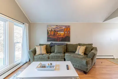 a living room with a couch and a table at H2 1 Bedroom Downtown Stamford in Stamford