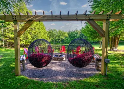 a swing set with two balls in a park at Mountain Blue Vista - Luxury retreat near Ski resorts with Pond, Firepit and Hot Tub in Windham