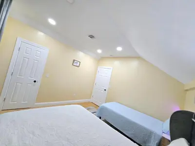 a bedroom with two beds and a door and a window at Large Group Home NJ Close To NYC Train in Boonton