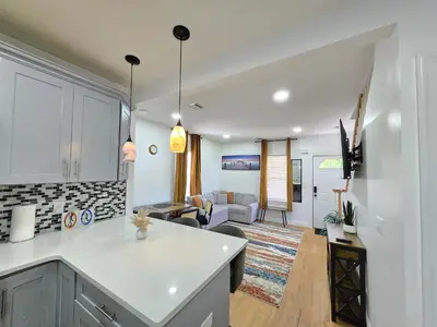 an open kitchen and living room with a couch at Large Group Home NJ Close To NYC Train in Boonton