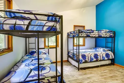 a room with two bunk beds and a bedroom at Lakefront New York Abode with Deck, Grill and Fire Pit in Mahopac