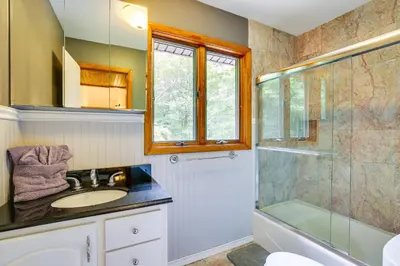 a bathroom with a sink and a glass shower at Lakefront New York Abode with Deck, Grill and Fire Pit in Mahopac