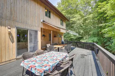 a table and chairs on the deck of a house at Lakefront New York Abode with Deck, Grill and Fire Pit in Mahopac