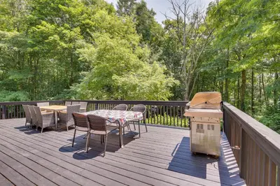 a deck with a grill and a table and chairs at Lakefront New York Abode with Deck, Grill and Fire Pit in Mahopac