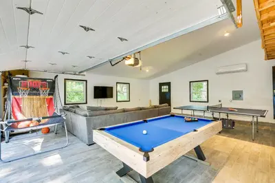 a living room with a pool table and a couch at Lakefront New York Abode with Deck, Grill and Fire Pit in Mahopac