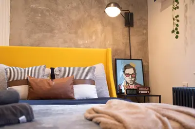 a bedroom with a bed with a yellow headboard at Urban Bedroom in Mount Vernon