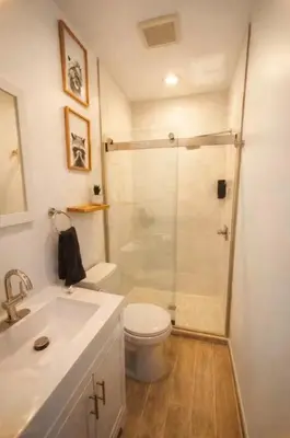 a bathroom with a shower and a toilet and a sink at Urban Bedroom in Mount Vernon