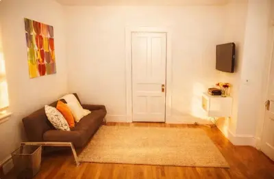 a living room with a couch and a door at Urban Bedroom in Mount Vernon