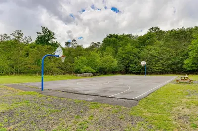 a basketball court in a park with a basketball hoop at On-Site Lakes and Pools Inviting Tobyhanna Home! in Tobyhanna
