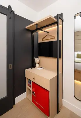 a room with a desk and a mirror at Little Charlie Hotel in New York