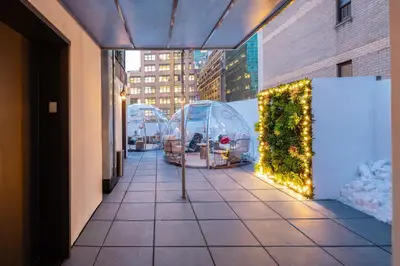 a walkway with a christmas display on a building at Little Charlie Hotel in New York