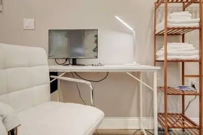 a bedroom with a desk with a tv and a chair at The Little Villa - 2Bed 1Bath Private Suite in Bristol