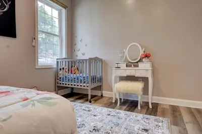 a baby room with a crib and a mirror at The Little Villa - 2Bed 1Bath Private Suite in Bristol