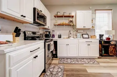 a kitchen with white cabinets and a stove top oven at The Little Villa - 2Bed 1Bath Private Suite in Bristol