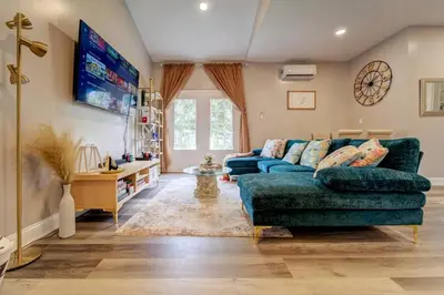 a living room with a blue couch and a tv at The Little Villa - 2Bed 1Bath Private Suite in Bristol