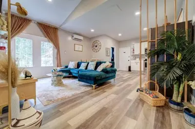 a large living room with a blue couch and a plant at The Little Villa - 2Bed 1Bath Private Suite in Bristol