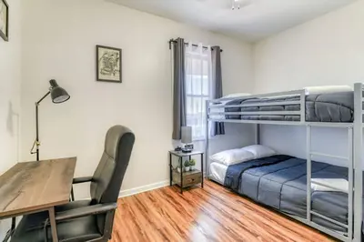 a bedroom with a desk and a bunk bed at TWO Modern Apartment Minutes to NYC in Jersey City