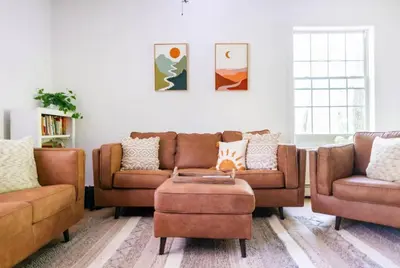 a living room with two couches and a table at Catskill Cabin with Firepit & Indoor Jacuzzi Tub in Catskill