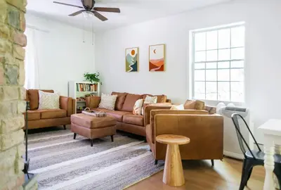 a living room with couches and a ceiling fan at Catskill Cabin with Firepit & Indoor Jacuzzi Tub in Catskill