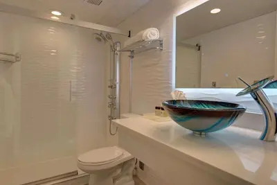 a bathroom with a bowl sink and a toilet at The Roslyn, Tapestry Collection by Hilton in Roslyn