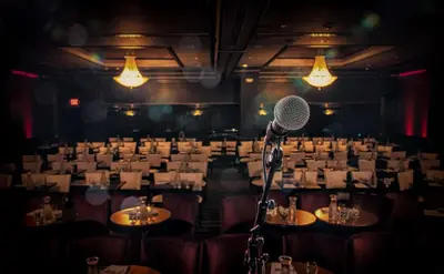 a microphone in a room with tables and chairs at The Roslyn, Tapestry Collection by Hilton in Roslyn