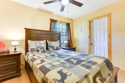 a bedroom with a bed and a ceiling fan at Pools and Ski Access Lackawaxen Cottage with Deck! in Lackawaxen
