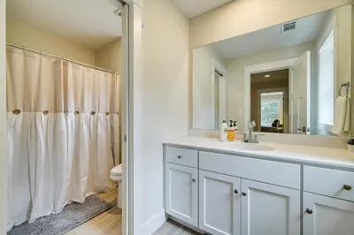 a white bathroom with a sink and a mirror at Cresco Countryside Oasis Surrounded by Nature! in Cresco