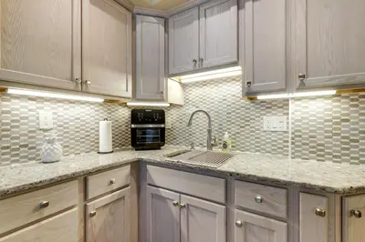 a kitchen with white cabinets and a sink at 3 Mi to Dtwn Springfield Winter Retreat with Office in Springfield