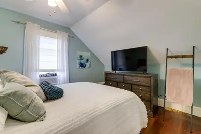 a bedroom with a bed with a television on a dresser at 3 Mi to Dtwn Springfield Winter Retreat with Office in Springfield