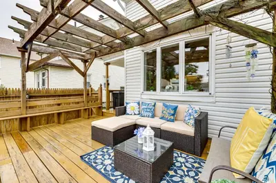 a patio with a couch and a table on a deck at 3 Mi to Dtwn Springfield Winter Retreat with Office in Springfield