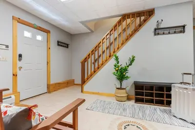 a living room with a staircase and a door at Spring skiing with friends & family - Berkshires in Otis