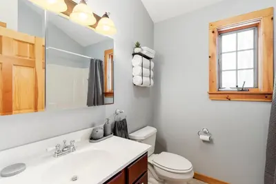 a bathroom with a sink and a toilet and a mirror at Spring skiing with friends & family - Berkshires in Otis