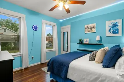 a blue bedroom with a bed and a ceiling fan at Cozy Retreat, Steps to Yale Bridgeport Hospital in Bridgeport