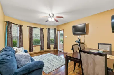 a living room with a blue couch and a tv at Cozy Retreat, Steps to Yale Bridgeport Hospital in Bridgeport