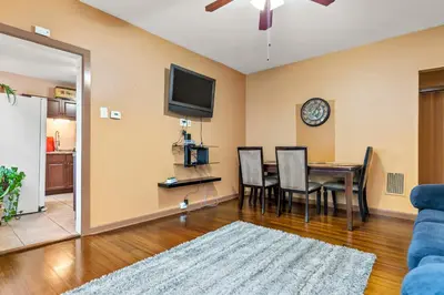 a living room with a dining room table and a tv at Cozy Retreat, Steps to Yale Bridgeport Hospital in Bridgeport