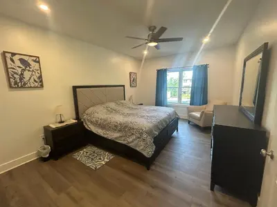 a bedroom with a bed and a ceiling fan at NEW 3 bedroom - Thoroughbred Farm & Lake Views! in Saratoga Springs