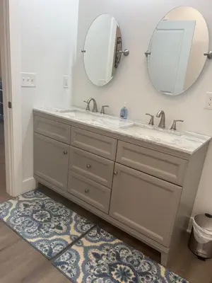 a bathroom with a sink and a mirror at NEW 3 bedroom - Thoroughbred Farm & Lake Views! in Saratoga Springs
