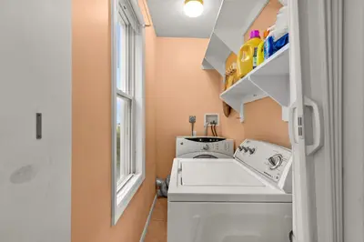 a laundry room with a washing machine and a window at Bedroom near Yale Hospital/Bridgeport in Bridgeport