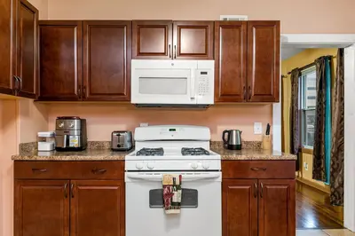 a kitchen with a white stove and a microwave at Bedroom near Yale Hospital/Bridgeport in Bridgeport
