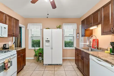 a kitchen with a white refrigerator in the middle at Bridgeport Bliss Solo Haven Near Yale & Downtown in Bridgeport