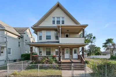 a house with a fence in front of it at Bridgeport Bliss Solo Haven Near Yale & Downtown in Bridgeport