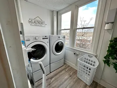 a laundry room with a washing machine and a window at 3-A Diamond in Yonkers, NY in Yonkers