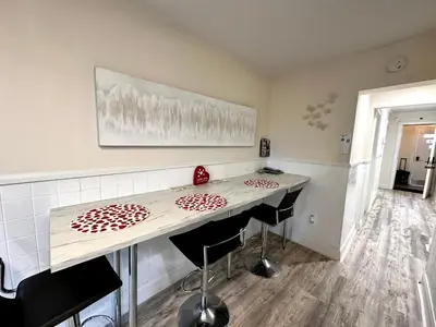 a kitchen with a counter and two stools at a table at 3-A Diamond in Yonkers, NY in Yonkers